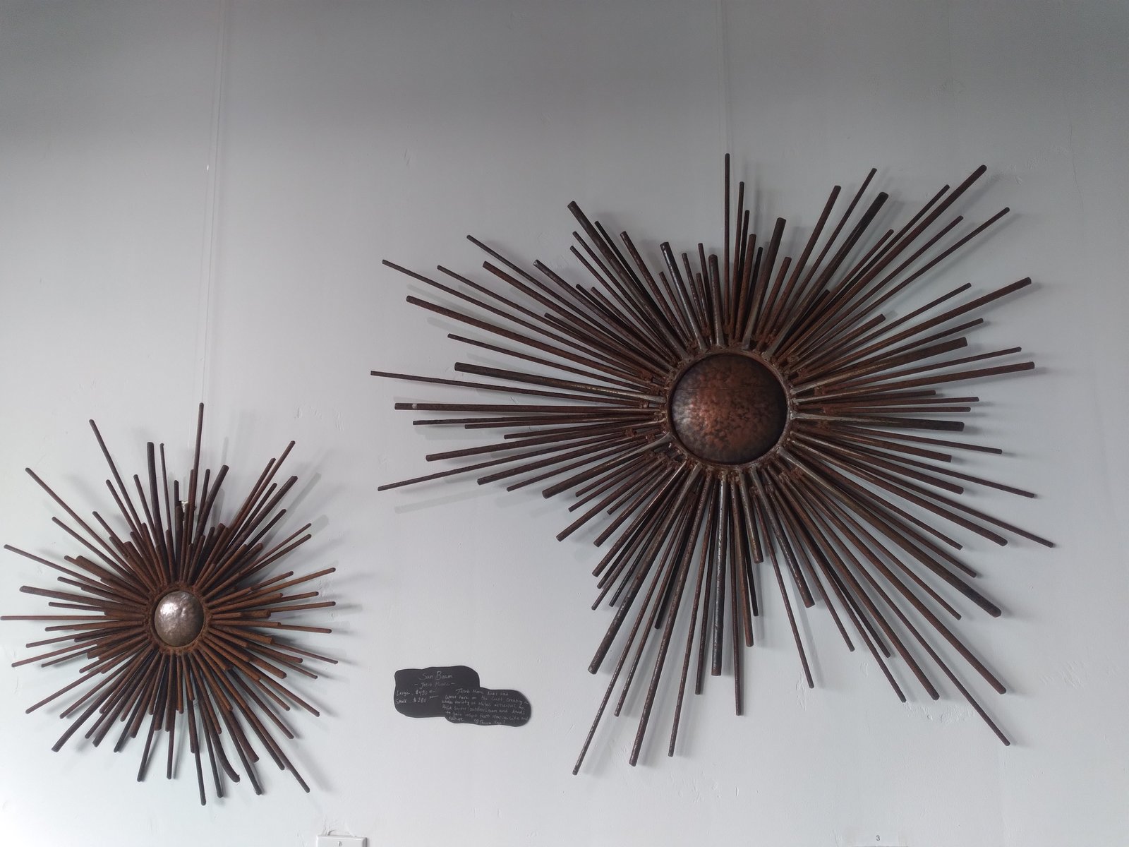 Paired radial wall sculptures